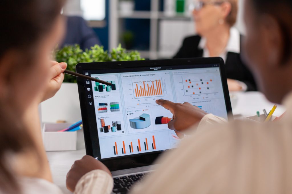 African american entrepreneur and coworkers analysing charts