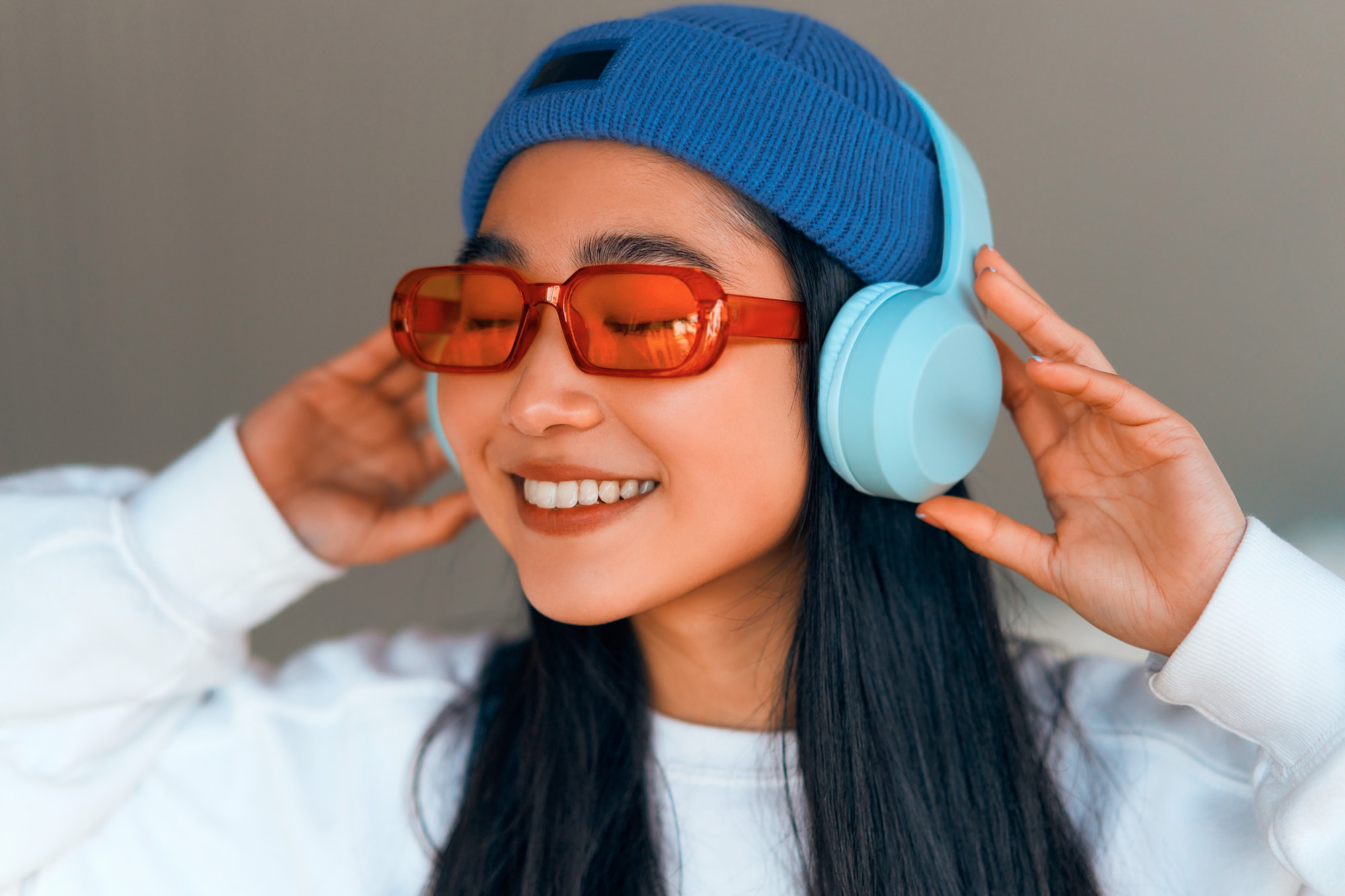 Asian woman wearing headphones